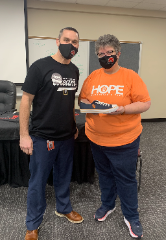 Chris Mitchell was presented a shoe from Samaritan’s Feet Regional Director Denise Blomberg following a shoe drive the two hosted with the Granite City School District #9 on Jan. 26, 2021 in Granite City, Ill.